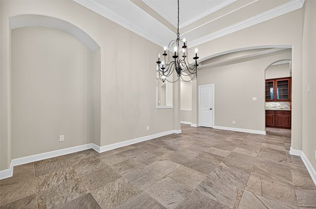 a view of a chandelier in big room and chandelier