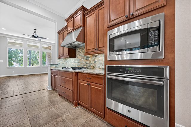a kitchen with stainless steel appliances a stove microwave and cabinets