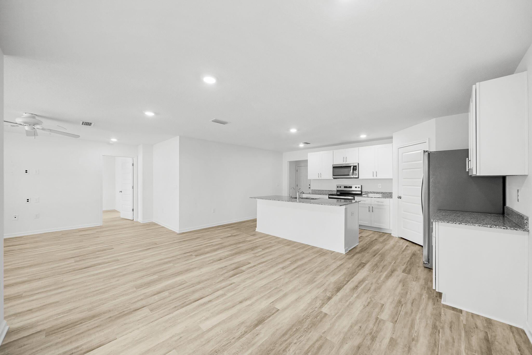 39 Riverwalk Crossing Freeport, FL 32439 - Photo 12 of 32 a large kitchen with kitchen island a sink stainless steel appliances and cabinets