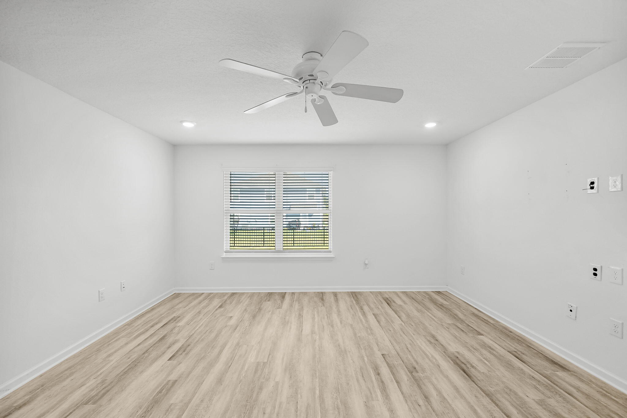 39 Riverwalk Crossing Freeport, FL 32439 - Photo 14 of 32 an empty room with a window and wooden floor