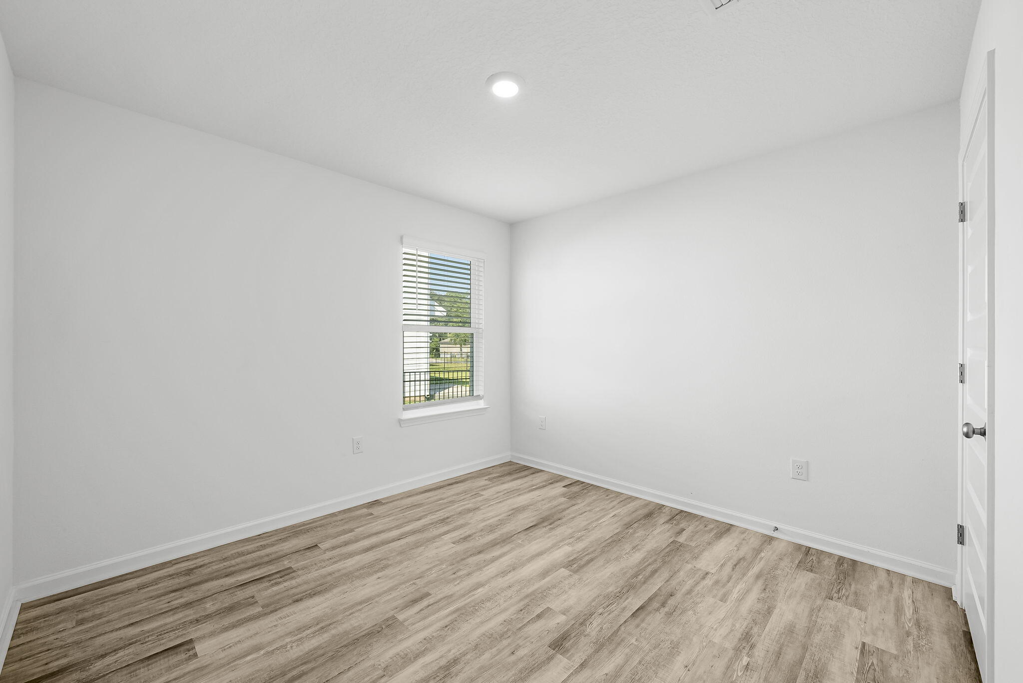 39 Riverwalk Crossing Freeport, FL 32439 - Photo 23 of 32 an empty room with wooden floor and windows