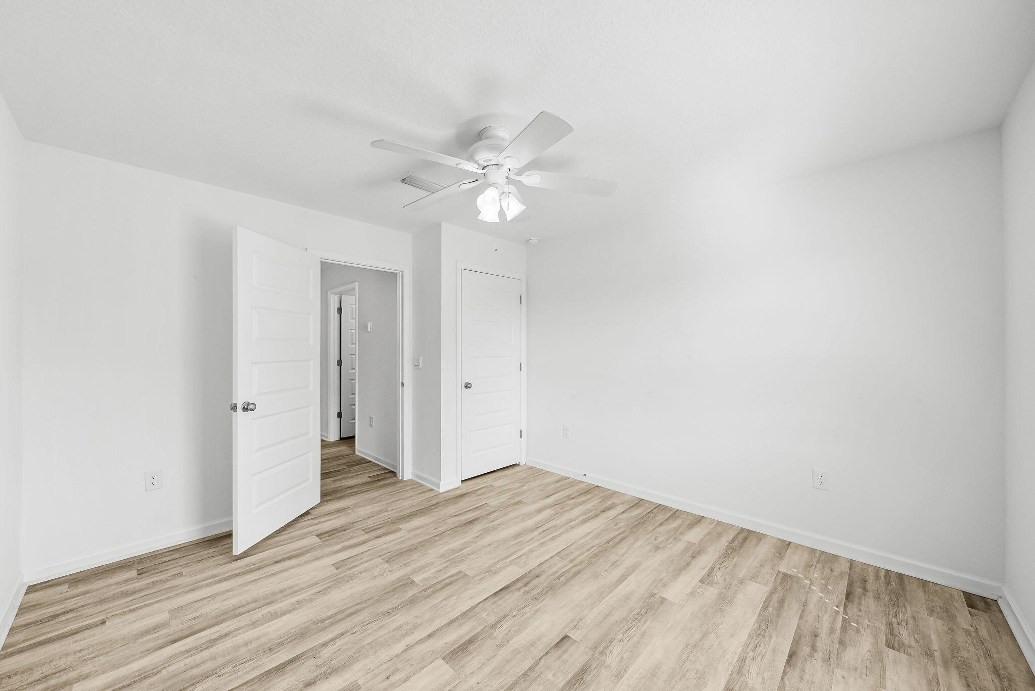 39 Riverwalk Crossing Freeport, FL 32439 - Photo 26 of 32 a view of a room with wooden floor and a ceiling fan