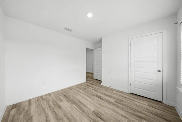 an empty room with wooden floor