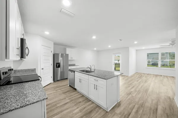 a large kitchen with kitchen island granite countertop a large counter top and sink