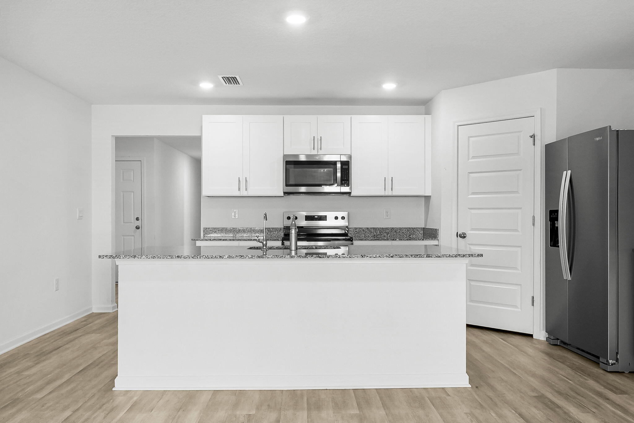 39 Riverwalk Crossing Freeport, FL 32439 - Photo 9 of 32 a kitchen with granite countertop a refrigerator and a stove top oven