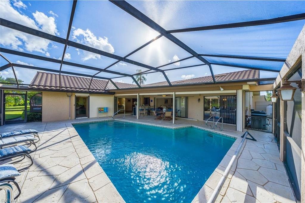 1101 Foxfire Lane Naples, FL 34104 - Photo 12 of 38 a view of a swimming pool with a patio