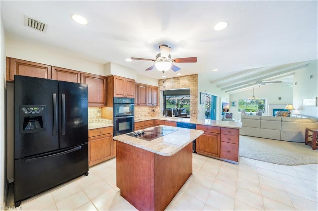 1101 Foxfire Lane Naples, FL 34104 - Photo 16 of 38 a kitchen with stainless steel appliances granite countertop a refrigerator a sink and a stove