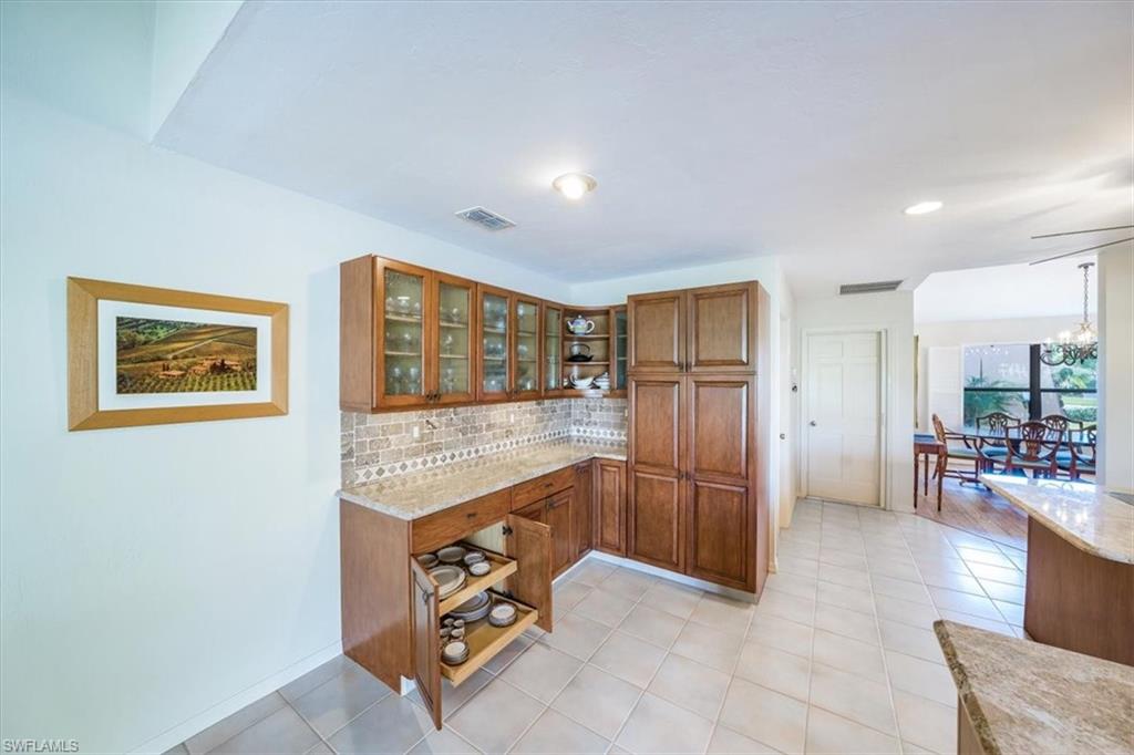 1101 Foxfire Lane Naples, FL 34104 - Photo 18 of 38 a kitchen with stainless steel appliances granite countertop a refrigerator and a sink