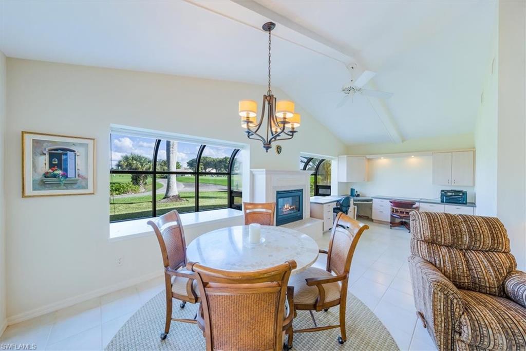 1101 Foxfire Lane Naples, FL 34104 - Photo 19 of 38 a view of a dining room with furniture wooden floor and a chandelier