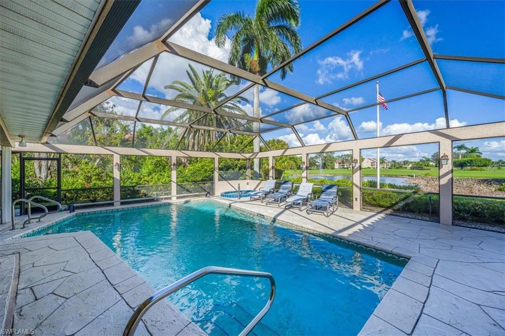 1101 Foxfire Lane Naples, FL 34104 - Photo 2 of 38 a view of a swimming pool with a patio