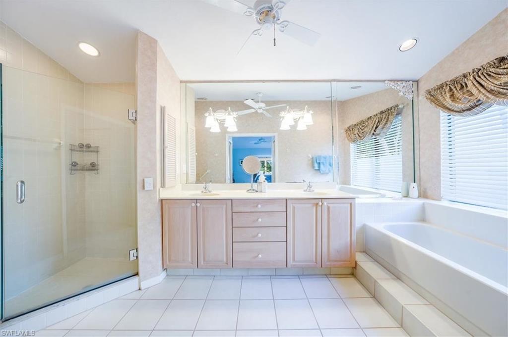 1101 Foxfire Lane Naples, FL 34104 - Photo 24 of 38 a bathroom with a tub sink and mirror