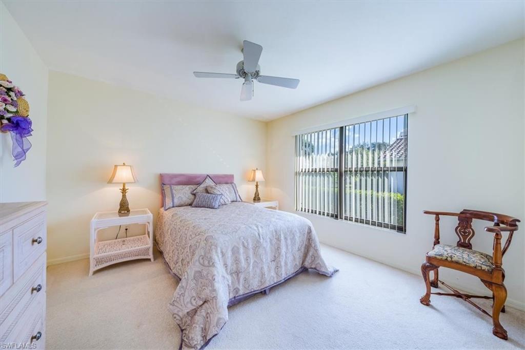 1101 Foxfire Lane Naples, FL 34104 - Photo 25 of 38 a bedroom with a bed and a couch