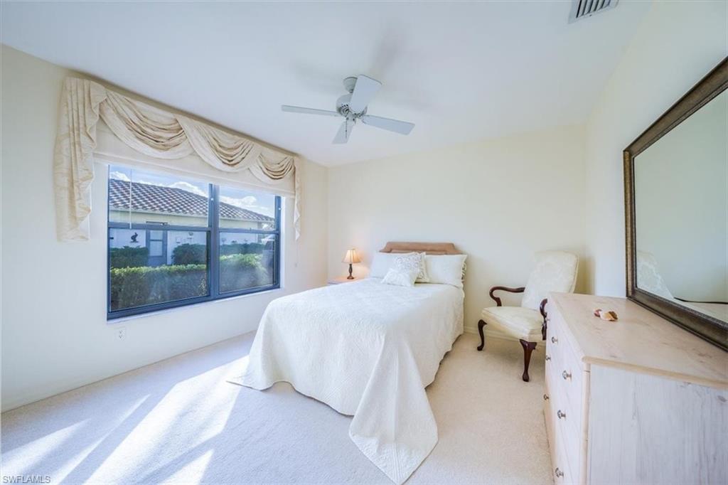 1101 Foxfire Lane Naples, FL 34104 - Photo 27 of 38 a bedroom with a bed and large window