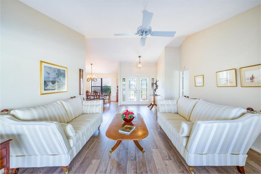1101 Foxfire Lane Naples, FL 34104 - Photo 6 of 38 a living room with furniture and a large window