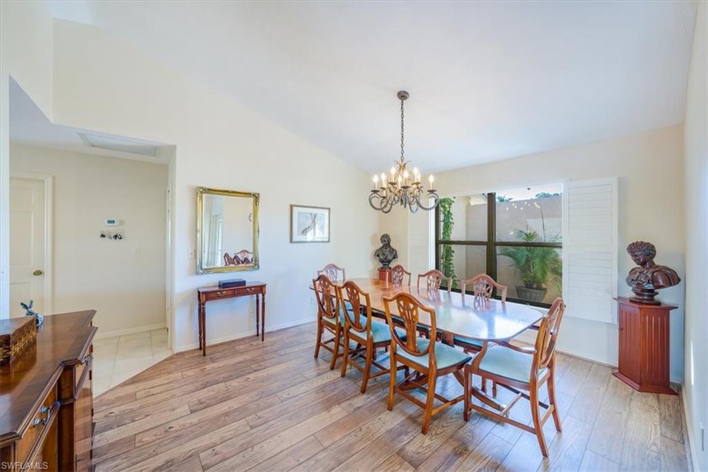 1101 Foxfire Lane Naples, FL 34104 - Photo 7 of 38 a view of a dining room with furniture window and wooden floor