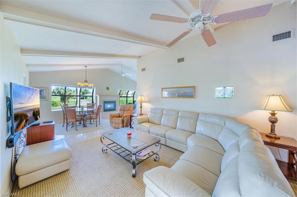 1101 Foxfire Lane Naples, FL 34104 - Photo 8 of 38 a living room with furniture and a large window