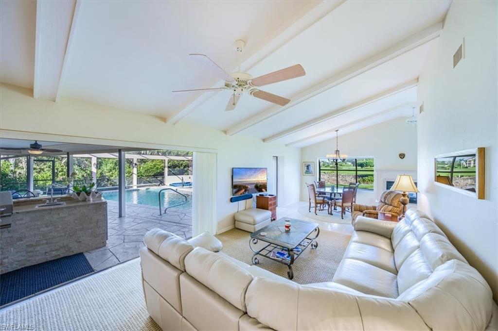 1101 Foxfire Lane Naples, FL 34104 - Photo 9 of 38 a living room with furniture and a large window