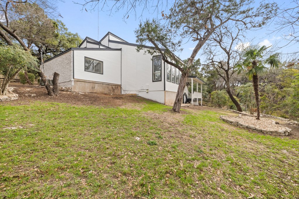 2204 Toro Canyon Road Austin, TX 78746 - Photo 26 of 26 View of side of home with a yard and a sunroom