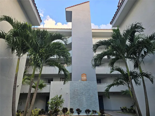 an aerial view of a house with a yard and garage