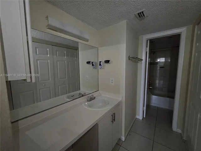 a bathroom with a sink and mirror