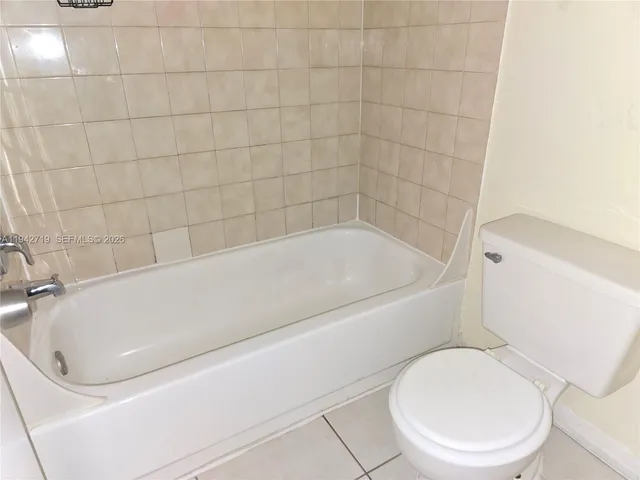 a bathroom with a toilet and bathtub