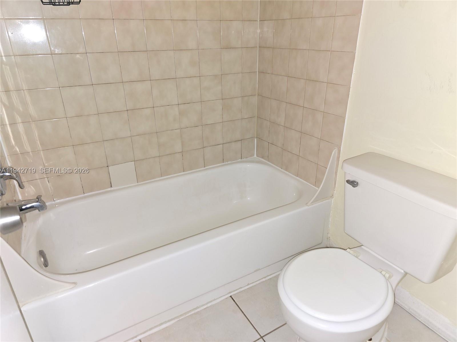 8215 Southwest 152nd Avenue, Unit G416 Miami, FL 33193 - Photo 12 of 17 a bathroom with a toilet and bathtub