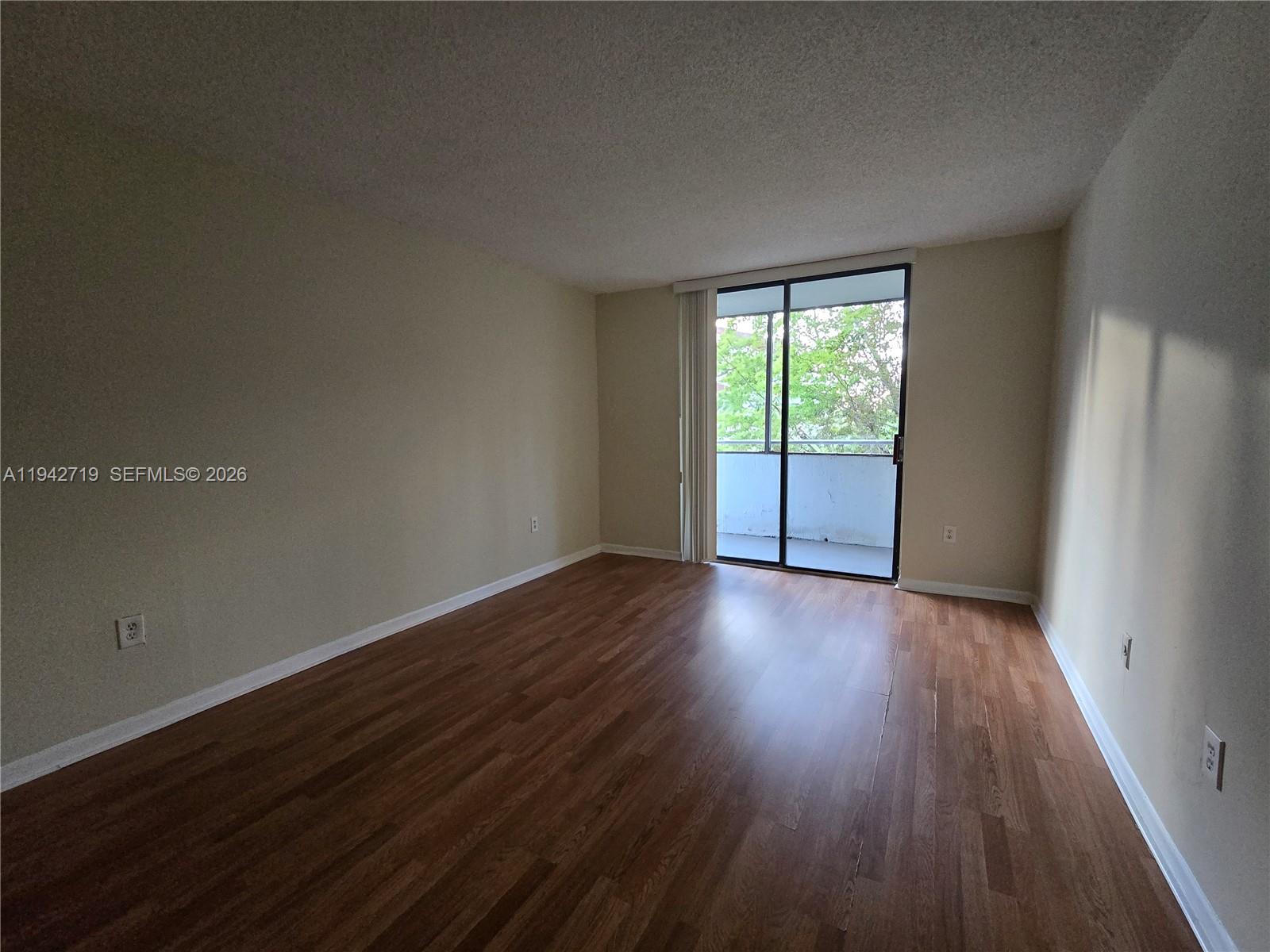 8215 Southwest 152nd Avenue, Unit G416 Miami, FL 33193 - Photo 14 of 17 a view of a room with wooden floor and window