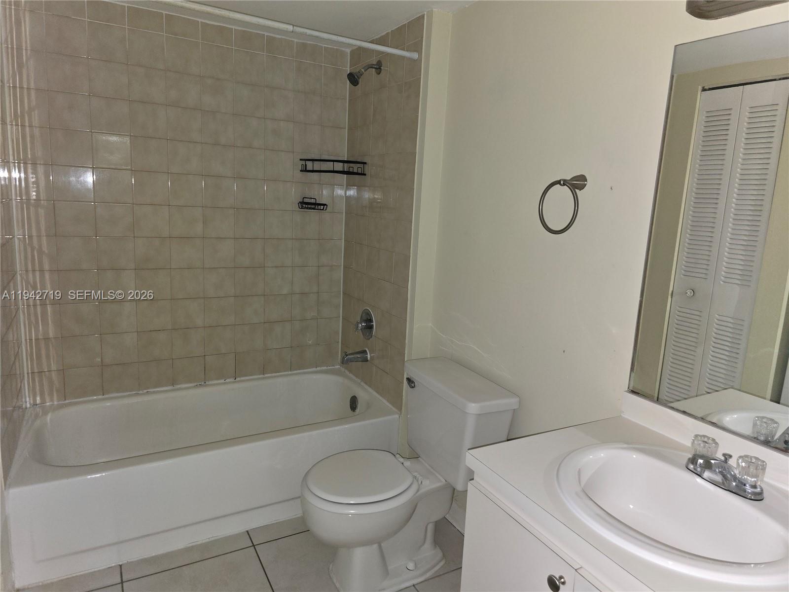 8215 Southwest 152nd Avenue, Unit G416 Miami, FL 33193 - Photo 15 of 17 a bathroom with a sink toilet and shower