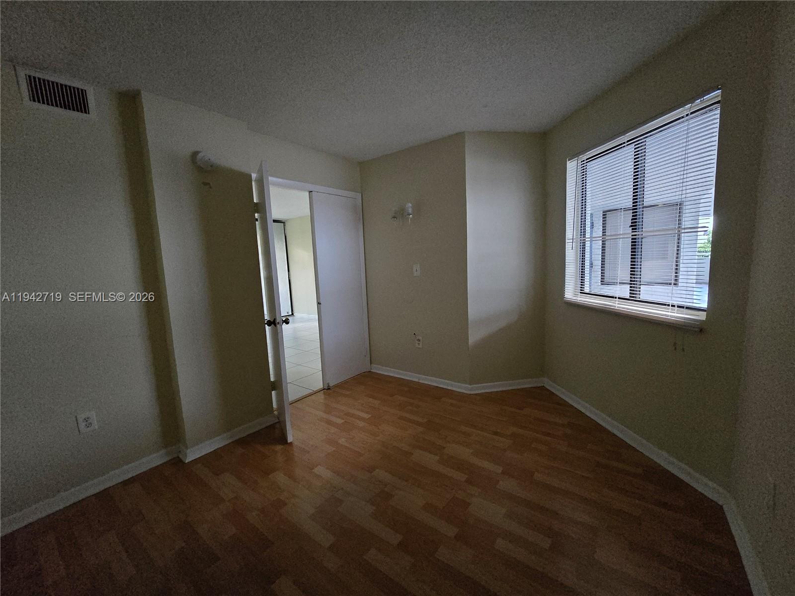8215 Southwest 152nd Avenue, Unit G416 Miami, FL 33193 - Photo 17 of 17 an empty room with windows and closet