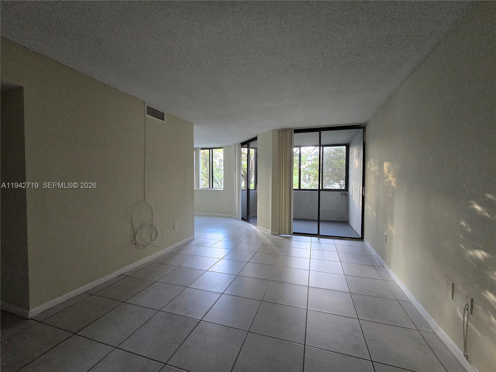 8215 Southwest 152nd Avenue, Unit G416 Miami, FL 33193 - Photo 5 of 17 a view of an empty room and window