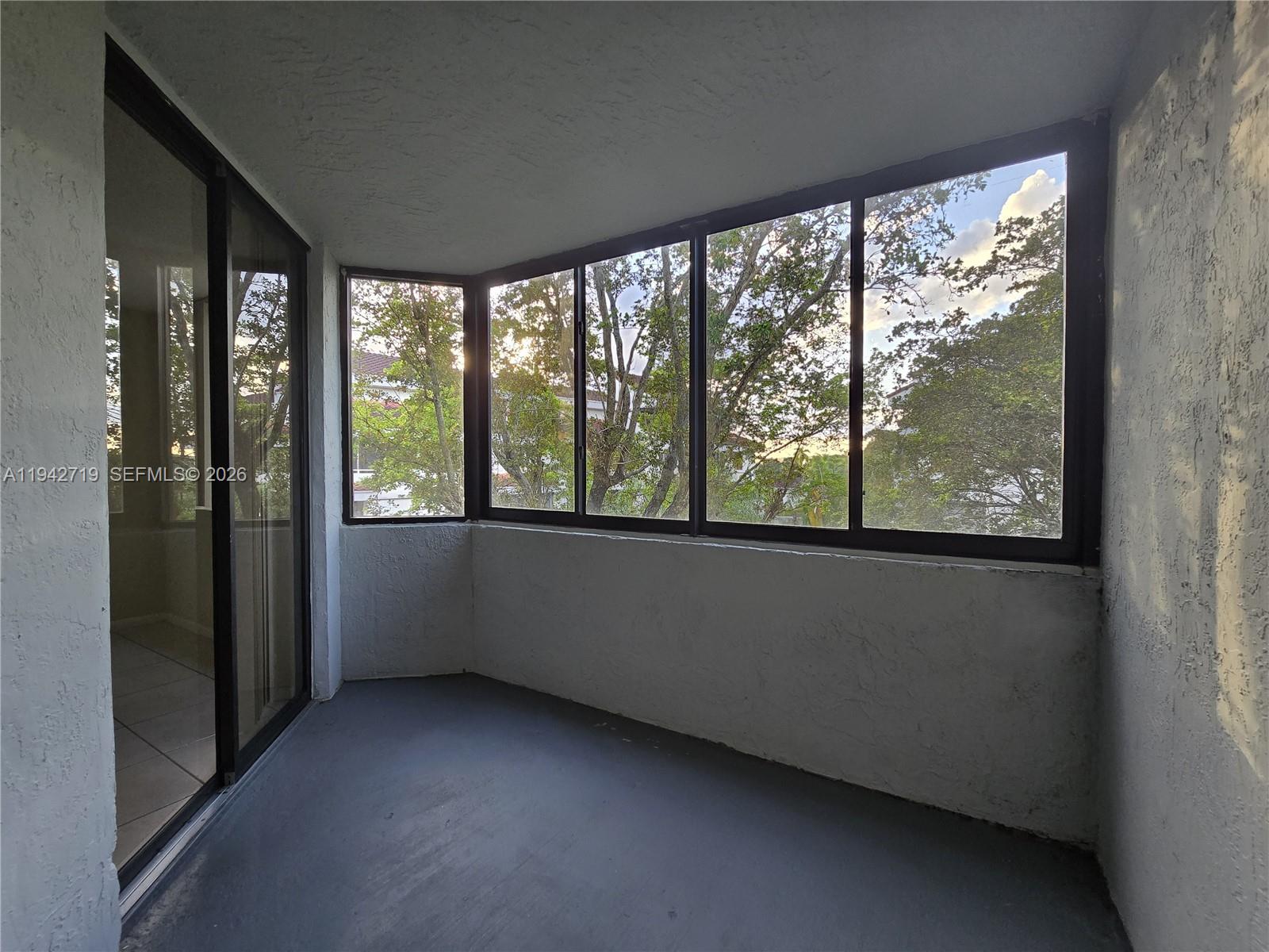 8215 Southwest 152nd Avenue, Unit G416 Miami, FL 33193 - Photo 7 of 17 a view of an empty room with a large window