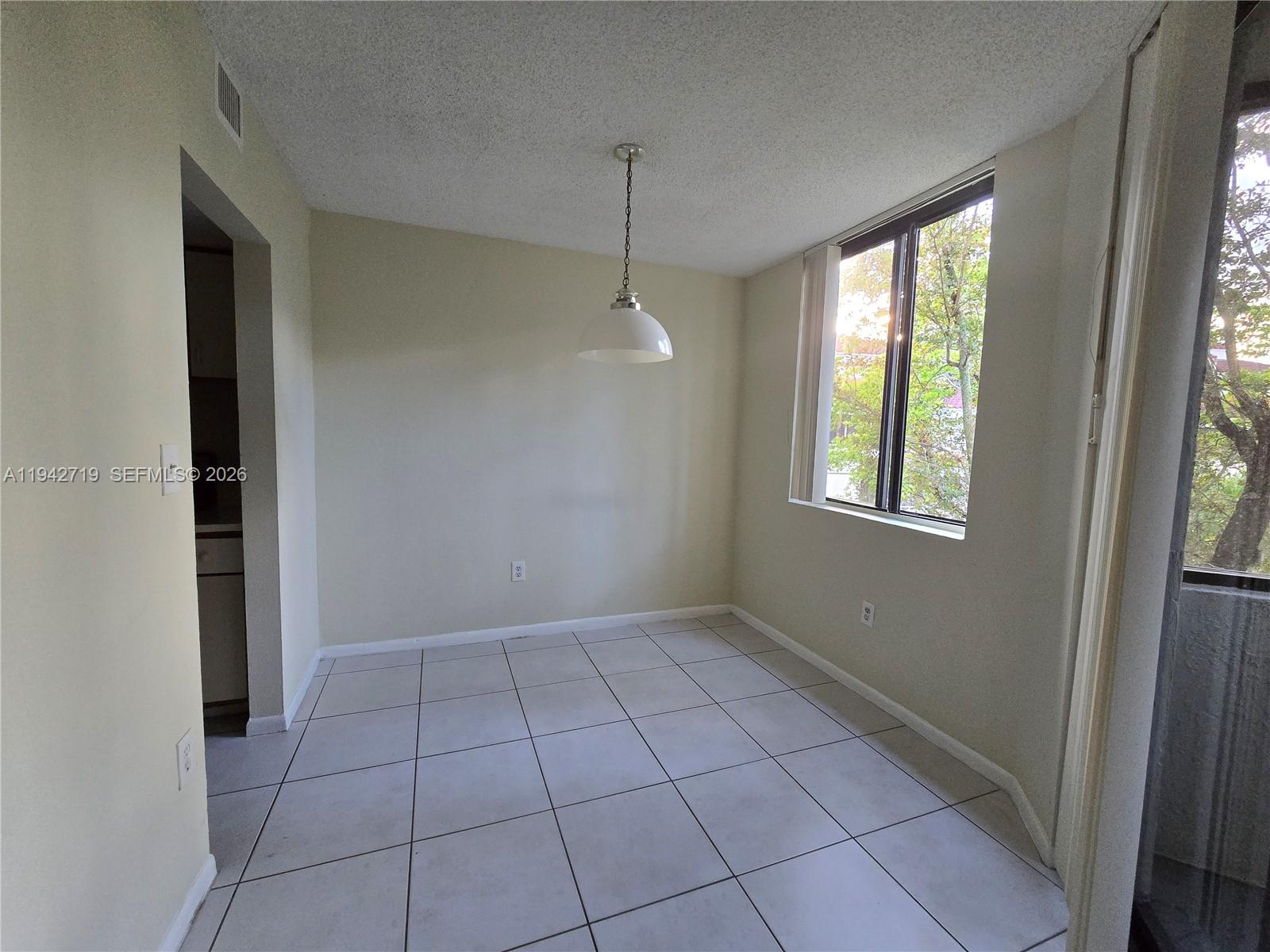 8215 Southwest 152nd Avenue, Unit G416 Miami, FL 33193 - Photo 8 of 17 a view of an empty room with a window