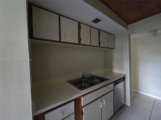 a kitchen with a sink and cabinets