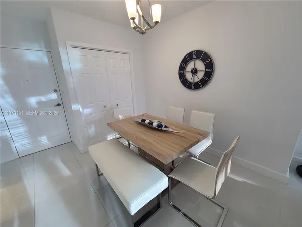 a view of a room that has a dining table and chairs