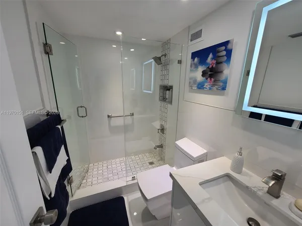 a bathroom with a sink toilet and shower