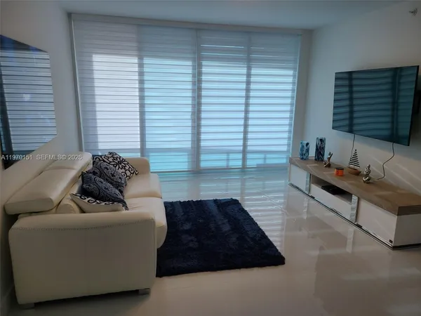 a living room with furniture and a large window