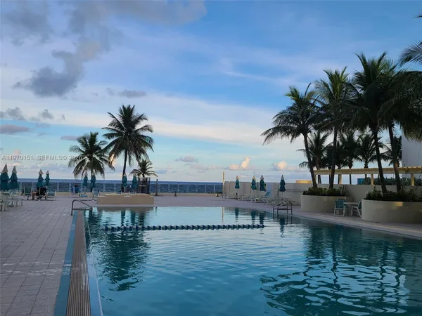 a view of ocean with palm trees