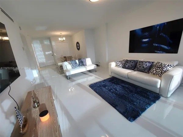 a living room with couches and a flat screen tv