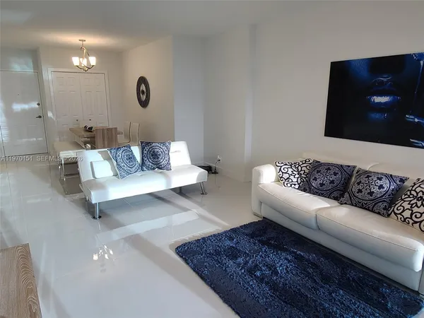 a living room with furniture and a rug
