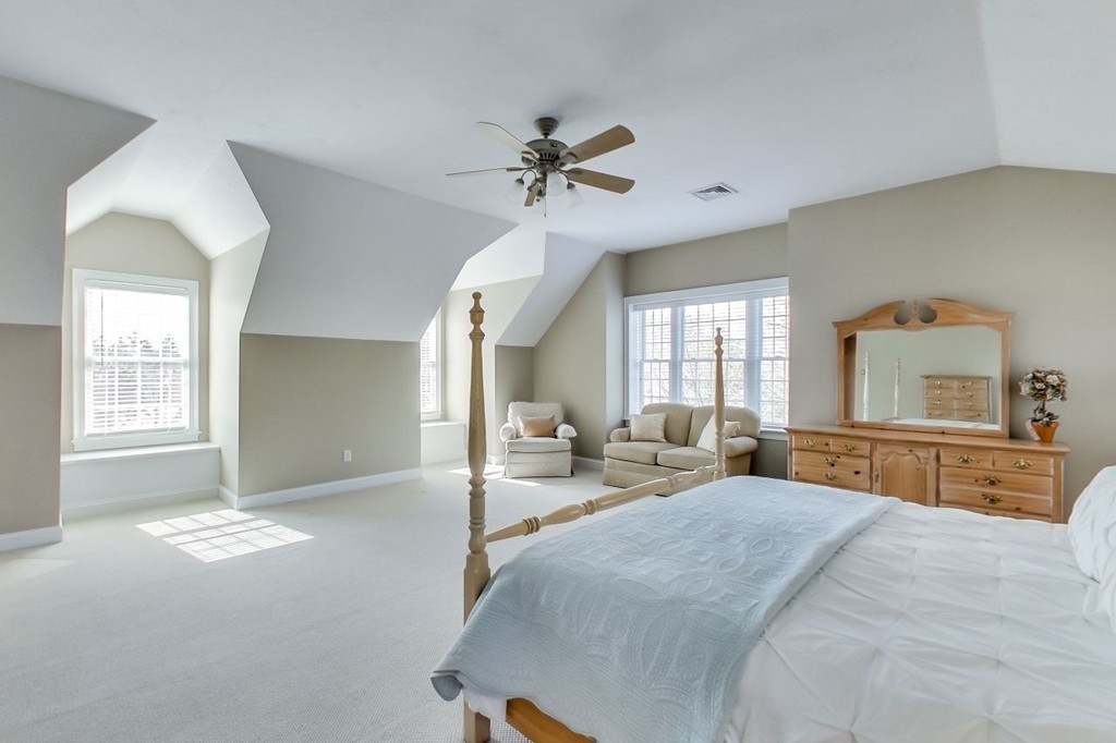 8 Rose Hill Road Hanover, MA 02339 - Photo 17 of 29 a spacious bedroom with a large bed and a chandelier