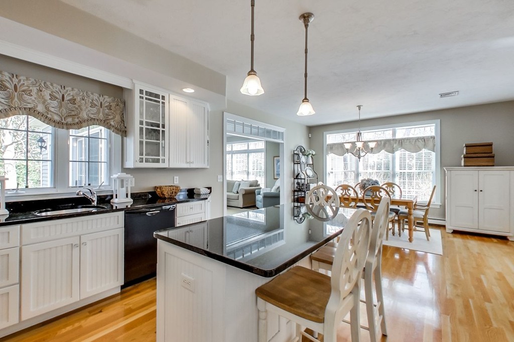 8 Rose Hill Road Hanover, MA 02339 - Photo 7 of 29 a kitchen with granite countertop a stove a sink a counter space dining table and chairs