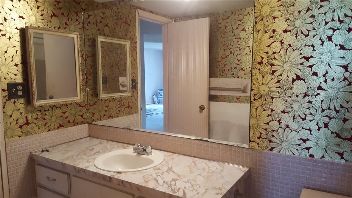 4880 Northwest 22nd Street, Unit 101 Lauderhill, FL 33313 - Photo 11 of 18 a bathroom with a sink and a mirror