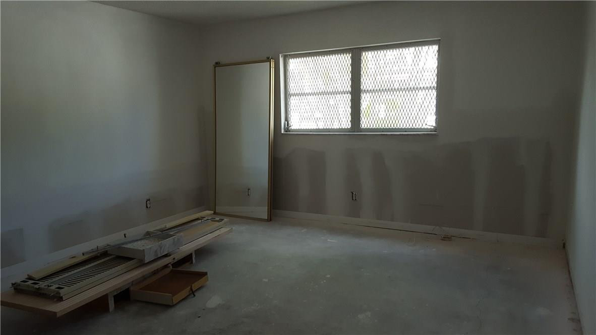 4880 Northwest 22nd Street, Unit 101 Lauderhill, FL 33313 - Photo 17 of 18 an empty room with windows