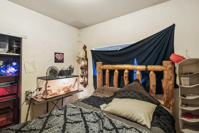 a bed room with a bed and a chair