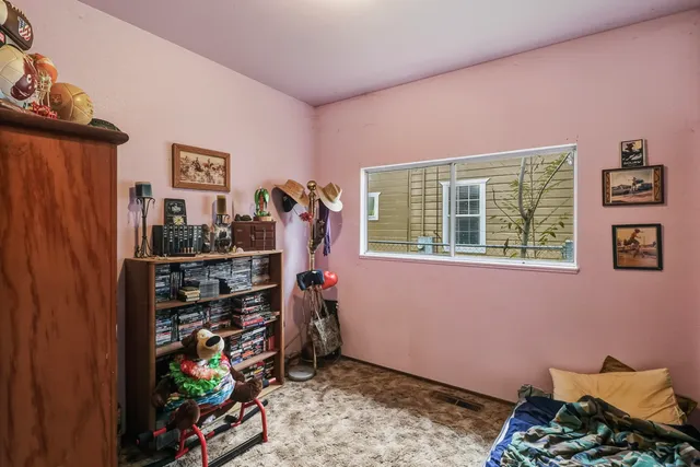 a bed room with a bed and a window