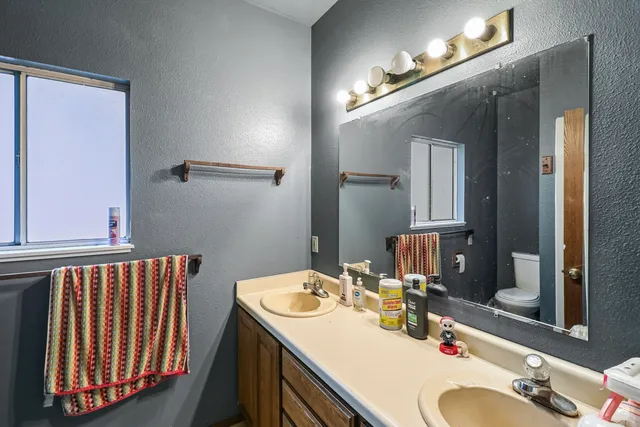 a bathroom with a sink vanity granite and a mirror