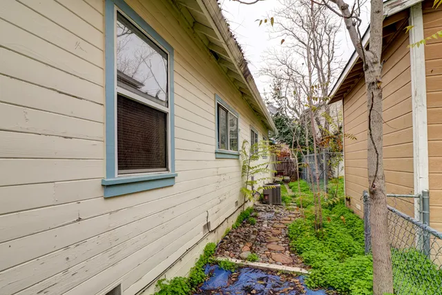 a front view of house with a garden
