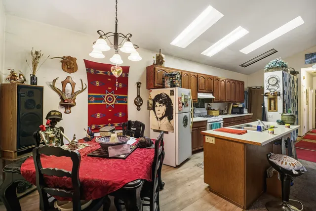 a view of a dining room with furniture and a chandelier