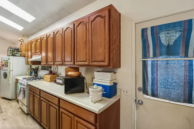 a kitchen with stainless steel appliances granite countertop a refrigerator sink and cabinets