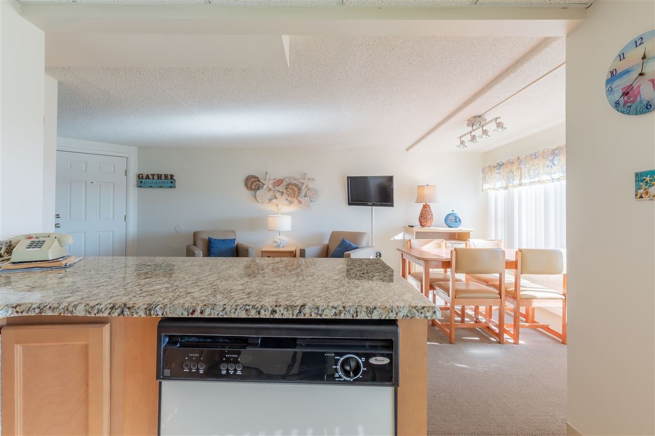 217 Beach, Unit 102 Cape May, NJ 08204 - Photo 13 of 30 a view of living room with granite countertop furniture and fireplace